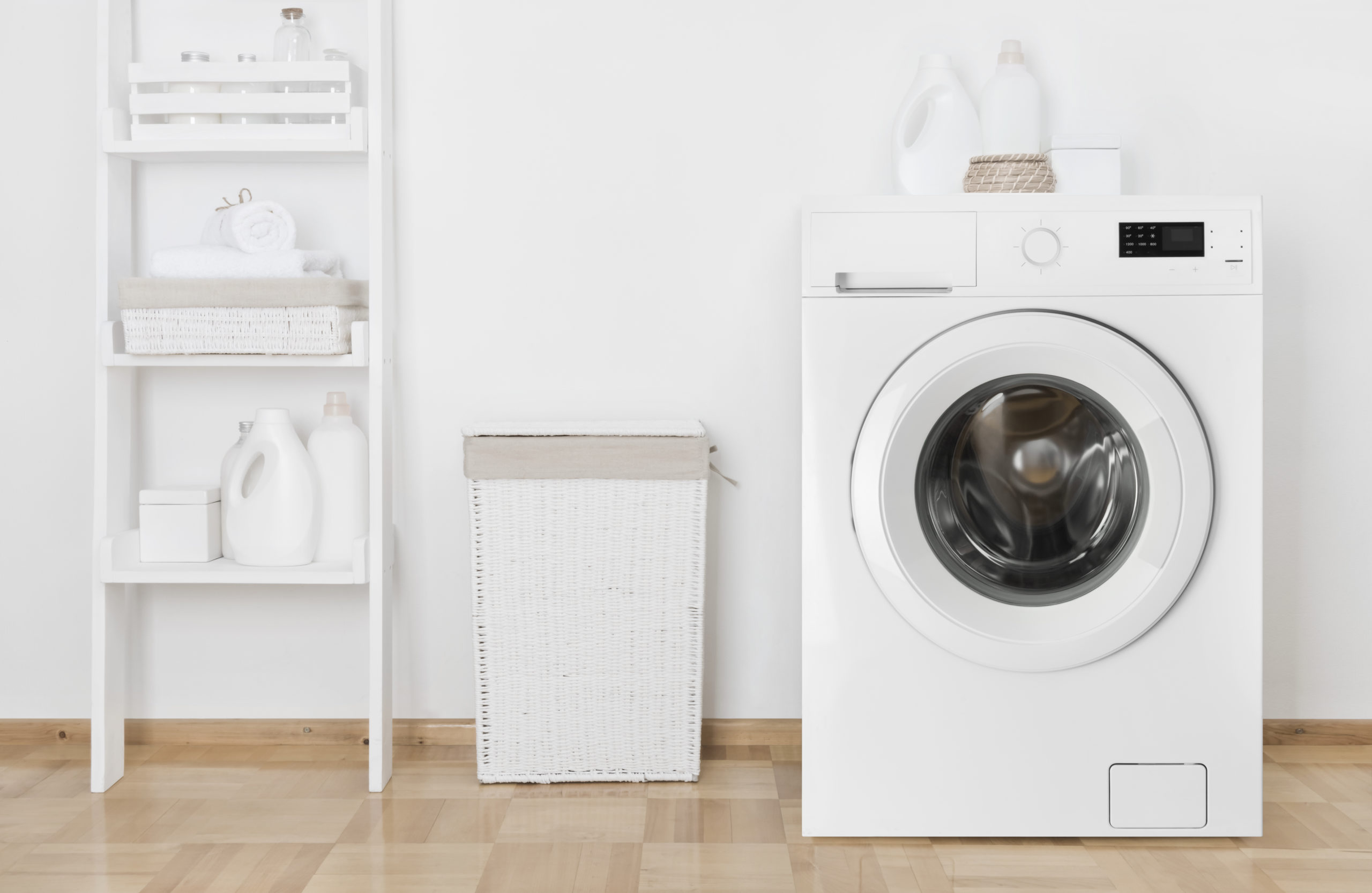 Interior of home laundry room with washing machine near wall